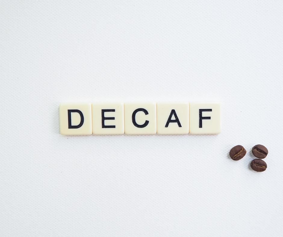 Is Decaf Coffee a Diuretic? scrabble tiles spelling out 'decaf' with three coffee beans on a white background